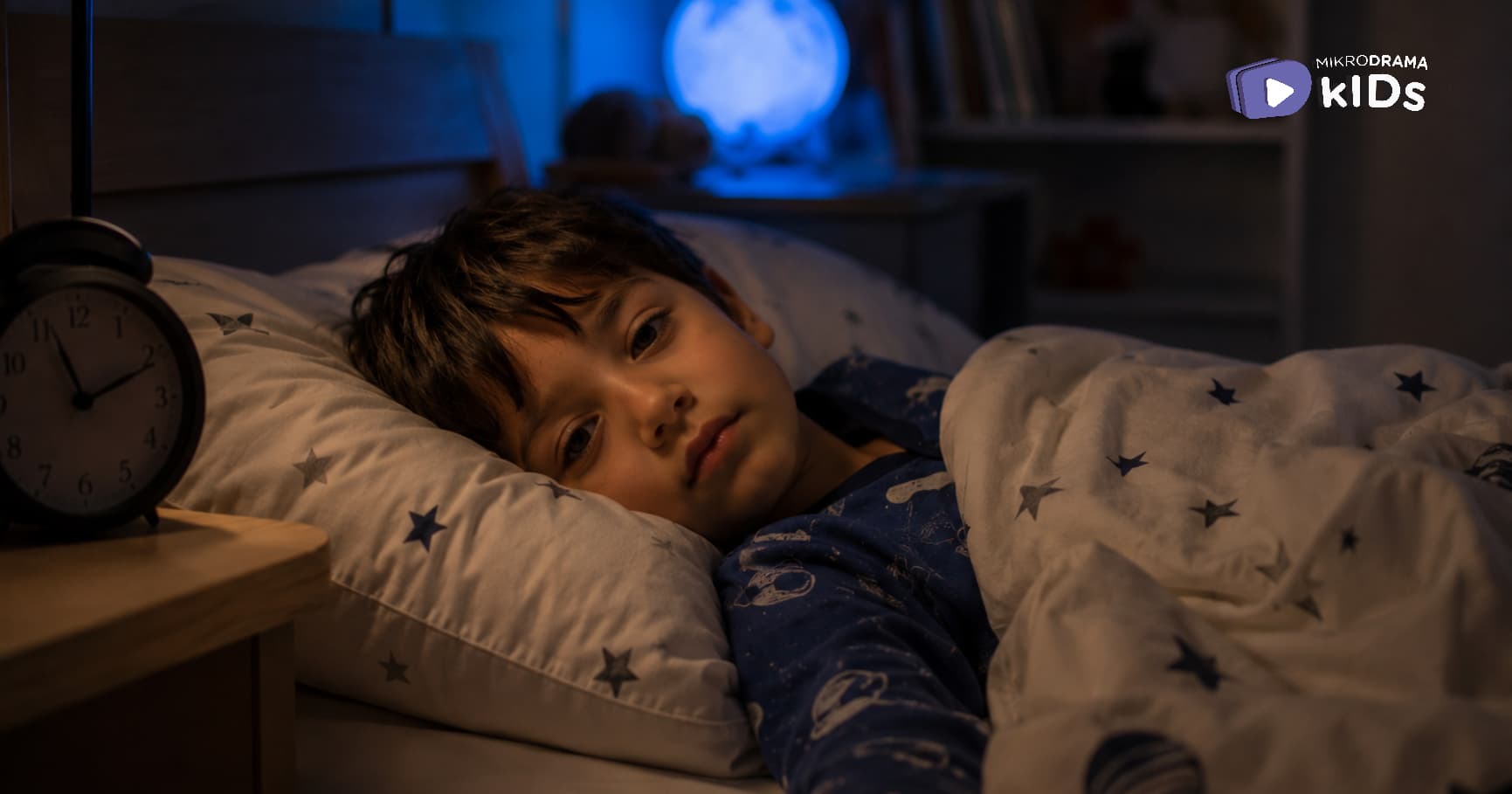 A boy laying in bed 